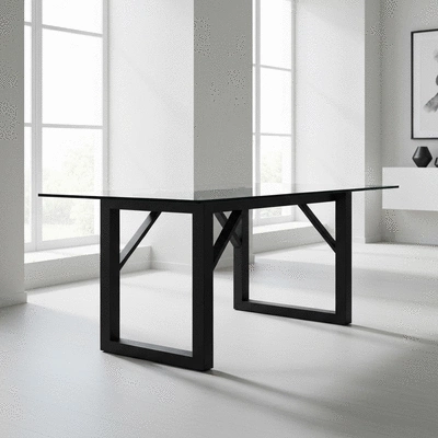 Minimalist contemporary dining table with glass top and metal legs in a bright modern room
