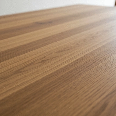 Close-up of a high-quality hardwood dining table surface showing rich grain patterns