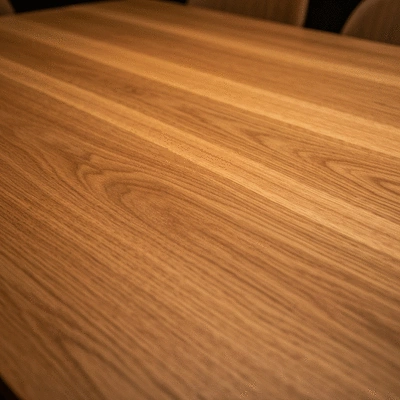 Close-up of a high-quality wooden dining table surface showing natural grain